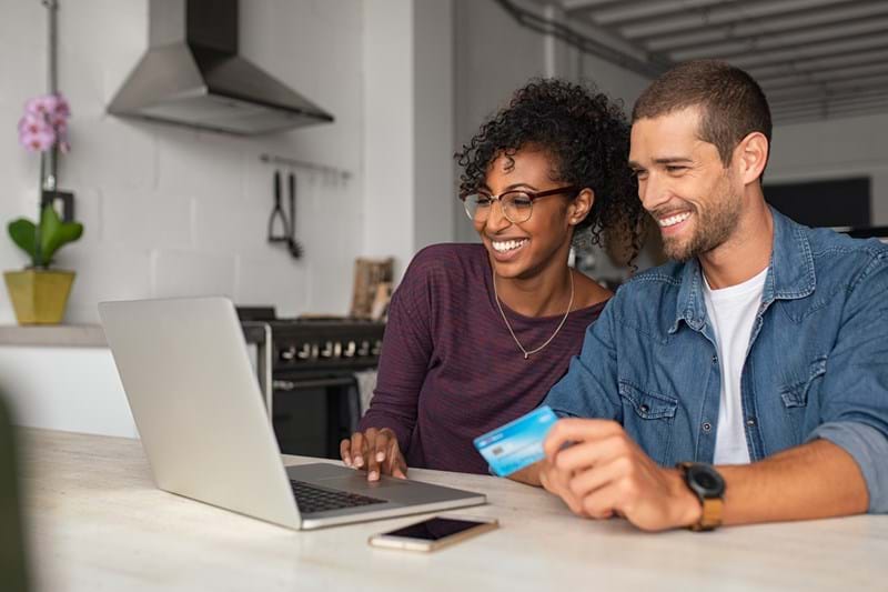 man-and-woman-managing-money-laptop-card